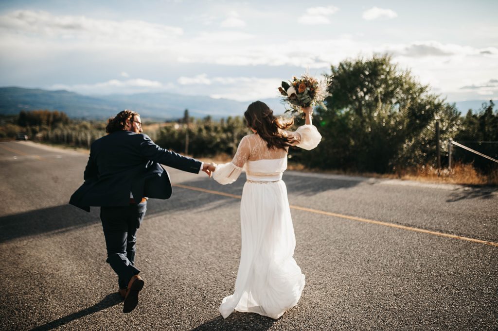 Couple running down the road after getting married